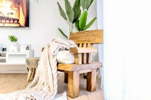 a room with a chair with a blanket at City Center Beachfront Apartments in Durrës +124 photos