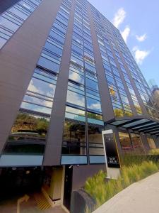a tall building with a lot of glass windows at AH/Loft vista a la ciudad, Cama Queen,Wifi,Usaquén in Bogotá
