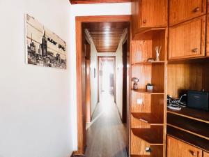 a hallway with wooden cabinets and a hallway leading into a room at Lisbon Alcantara LX in Lisbon