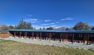 a large black building with a blue roof at Mt Potts Lodge in Ashburton Lakes