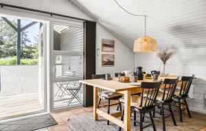 a dining room with a table and chairs at Three-Bedroom Holiday Home In Thisted in Nørre Vorupør