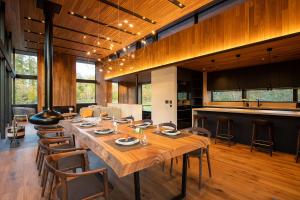 a large dining room with a large wooden table at Sena in Niseko +5 photos