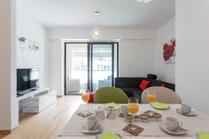 a living room with a table with food and wine glasses at Apartment Navigatio with parking in Dubrovnik