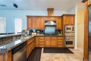 a kitchen with wooden cabinets and stainless steel appliances at El Tranquillo in Templeton