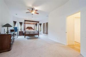 a bedroom with a bed and a ceiling fan at El Tranquillo in Templeton