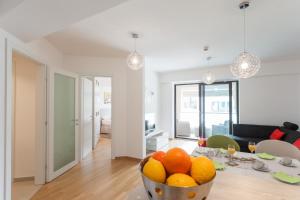 a living room with a bowl of oranges on a table at Apartment Navigatio with parking in Dubrovnik