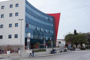 a large glass building with people standing outside of it at Apartment Navigatio with parking in Dubrovnik