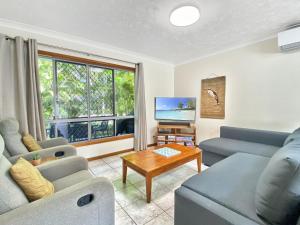 a living room with a couch and a table at Island Magic Townhouse 5 in Arcadia
