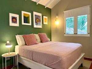 a bedroom with a bed and a window at PETRAKl HOMES in Las Galeras