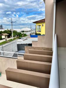 a view from the balcony of a house with stairs at Casa 2 Suítes+1 - VISTA MAR e 15km do Beto Carrero - 50 metros da PRAIA - Area de LAZER com Churrasqueira - Wi-Fi e Cozinha Completa in Piçarras