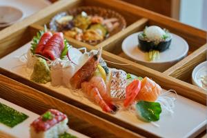 a tray of different types of sushi on plates at IJE Namhae in Namhae