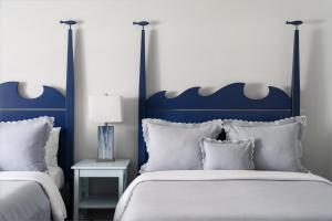 a bedroom with a blue and white bed with pillows at Southampton Inn in Southampton