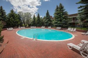 a large swimming pool with chairs at Little America Hotel - Wyoming in Little America