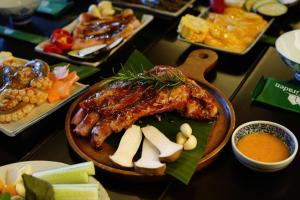 a plate of food with meat and cheese and other foods at Du Yen Garden Mang Đen in Kon Von Kla +32 photos