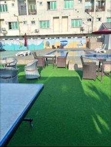 a patio with tables and chairs and a pool at New Horizon 2 Estate Ikate in Lekki +5 photos