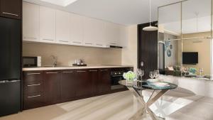 a large kitchen with a glass table in it at InterContinental Residences Nha Trang by IHG in Nha Trang