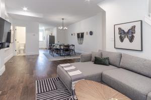 a living room with a couch and a dining room at Ann Avenue Modern 3BR Home, Near Downtown with Free Parking in Saint Louis