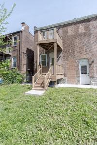 a house with a deck on the side of a building at Ann Avenue Modern 3BR Home, Near Downtown with Free Parking in Saint Louis
