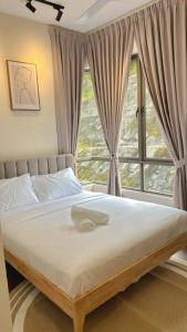 a bed in a bedroom with a large window at Vika Homestay in Brinchang