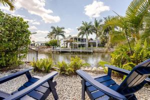 two blue chairs sitting next to a body of water at Waterfront Studio Just minutes to Naples Beaches in Naples