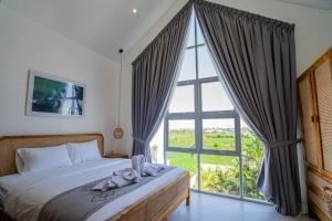 Ένα ή περισσότερα κρεβάτια σε δωμάτιο στο Villa Greenwall Canggu +31 φωτογραφίες