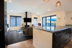 a kitchen and living room with a large counter top at Family Size Holiday Home With Remarkable Views & Sauna, Close to Town in Queenstown