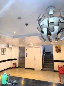 a large chandelier hanging from the ceiling of a hallway at BGC Suites Uptown in Makati