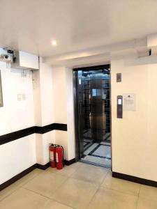 an entrance to a building with two red fire hydrants at BGC Suites Uptown in Makati