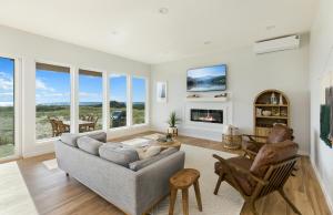a living room with a couch and a fireplace at The Beachcomber - Oceanfront Getaway! in Westport