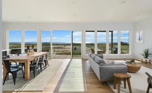 a living room with a table and a couch at The Beachcomber - Oceanfront Getaway! in Westport