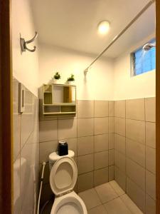 a bathroom with a toilet in a room at BGC Suites Uptown in Makati +19 photos
