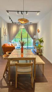 a dining table and chairs in a living room at Vika Homestay in Brinchang