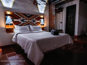 Postel nebo postele na pokoji v ubytování Hotel Hacienda Anacaona - San Agustín