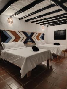 Postel nebo postele na pokoji v ubytování Hotel Hacienda Anacaona - San Agustín