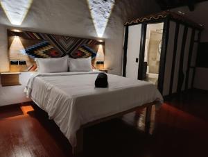 Postel nebo postele na pokoji v ubytování Hotel Hacienda Anacaona - San Agustín