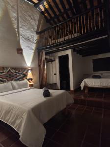 Postel nebo postele na pokoji v ubytování Hotel Hacienda Anacaona - San Agustín