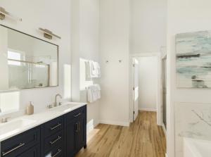a bathroom with a sink and a mirror at The Beachcomber - Oceanfront Getaway! in Westport +17 photos