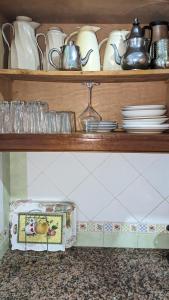 a shelf with plates and dishes on it at Marina Smir Compounds Pool & Beach in Marina Smir +11 photos
