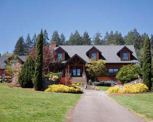 a log home with a driveway in front at Franziska Haus in Dundee