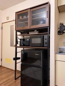 a kitchen with a microwave and a microwave oven at STAY Moiwayama in Sapporo +57 photos