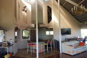 a kitchen and living room with a stove in a house at Hacienda las Nubes in Turrialba