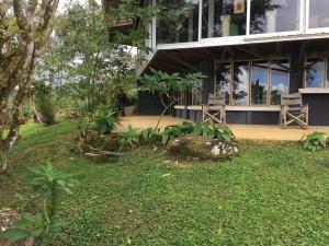 a person standing in front of a building at Hacienda las Nubes in Turrialba