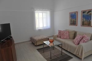 a living room with a couch and a table at Kalymnos residence in Kalymnos