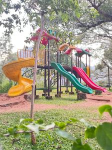 a playground with colorful slides in a park at Chittadiyil Homestay in Anachal