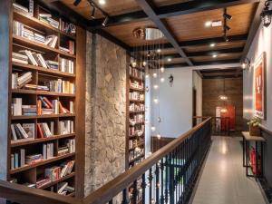 a staircase in a library with bookshelves at Montem Villa - Venuestay in Lương Sơn
