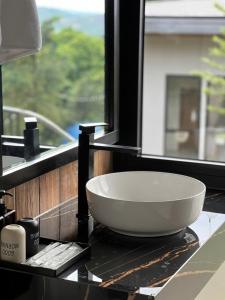 a white bowl sitting on a counter next to a window at Montem Villa - Venuestay in Lương Sơn
