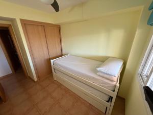 a small room with a bed and a window at Ático Roquetas in Roquetas de Mar +15 photos