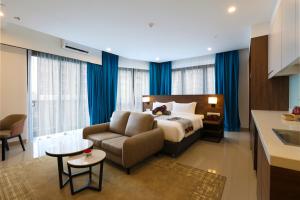 云顶高原Signata Genting Highlands的一间卧室，里面有一张床、一张沙发和一把椅子 更多21张照片