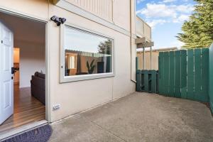 a door to a house with a window on it at Cozy 2-Bedroom Retreat in Pacifica in Pacifica