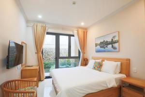 a bedroom with a bed and a large window at Cerasoi Boutique Dalat Hotel in Da Lat